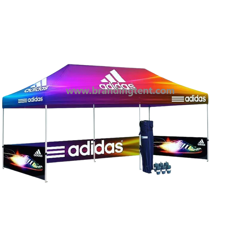 Large branded event tent with printed banner walls set up outdoors