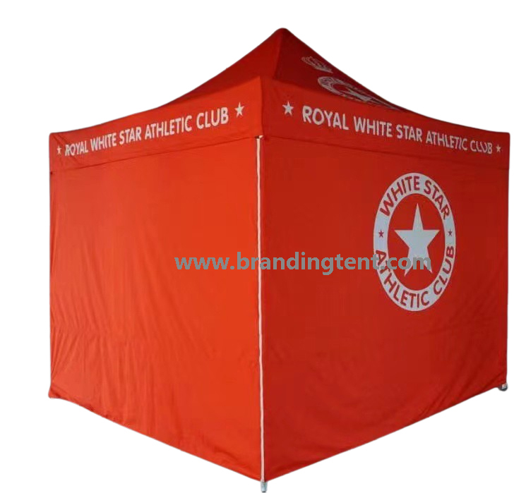 Full-walled printed tent standing outdoors, wind-ready with anchored legs