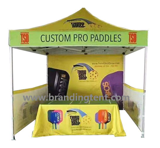 Printed stall tent with walls and table cover set up as a street fair vendor stand