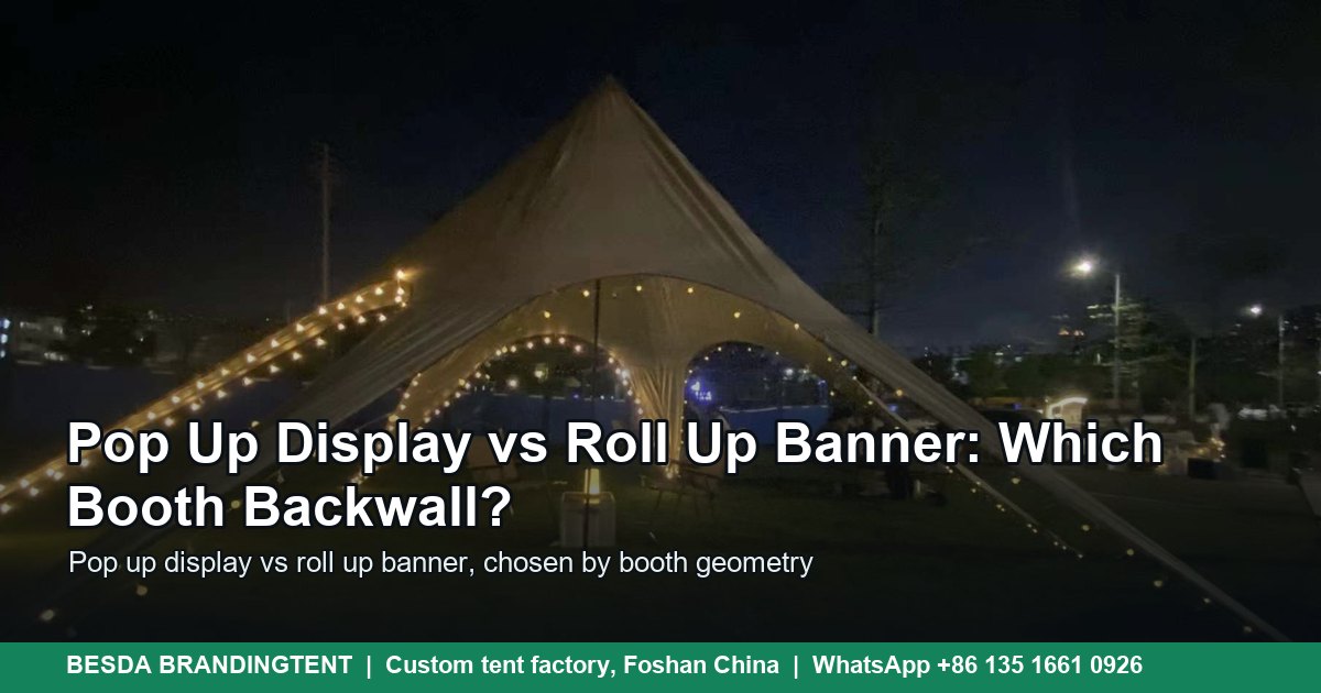 White star-shaped event canopy tent with a central mast and warm lights at dusk