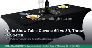 Black stretch trade show table cover on a 6 ft table set with plates and a bottle