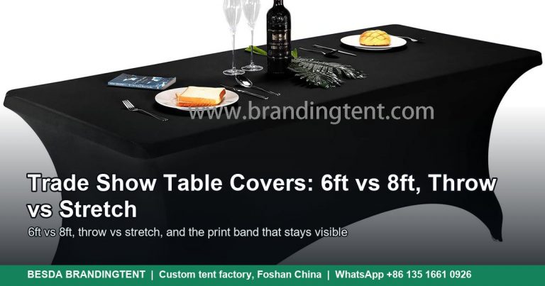 Black stretch trade show table cover on a 6 ft table set with plates and a bottle